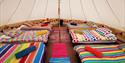 Six colourful beds in tent