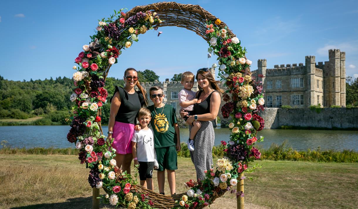 Family under floral sculpture