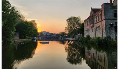 Sunset on the River Medway with the Archbishop's Place of Maidstone on the right.