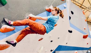 Girl suspended on the climbing wall