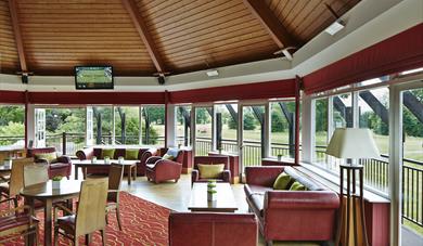 Zest and Mezzanine Bar with tables, a TV and a view