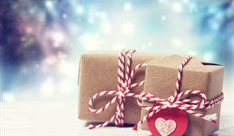 Two brown box parcels with red and white string and hearts
