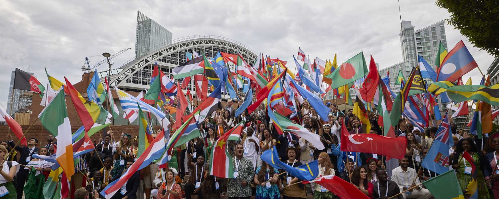 Delegates waving flags outside a conference venue