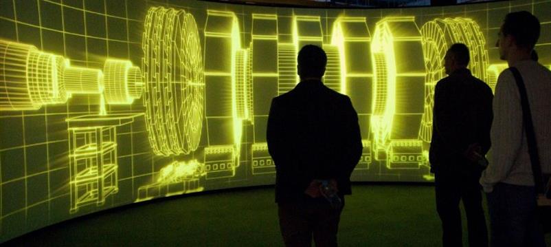 Museum visitors inspecting particle collider exhibition