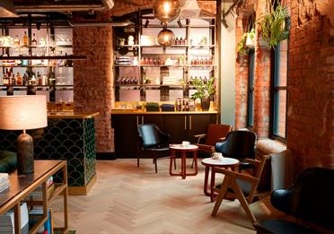 Red brick interior and seating at LEVEN Manchester