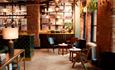 Red brick interior and seating at LEVEN Manchester