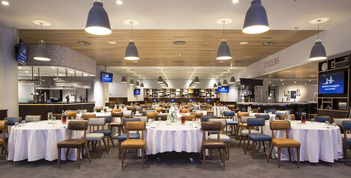 Hospitality suite with chairs and tables set out at Manchester City Football Club