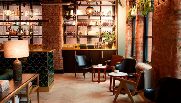 Red brick interior and seating at LEVEN Manchester