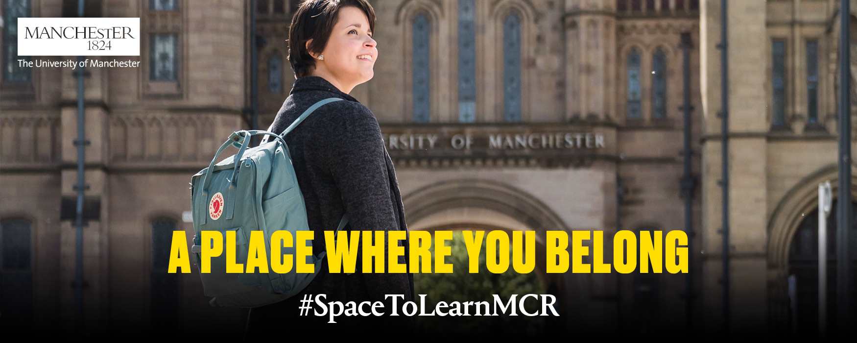 Student in front of the University of Manchester entrance