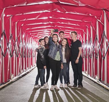 Family taking a selfie in the tunnel at the Manchester United Museum and Stadium Tour