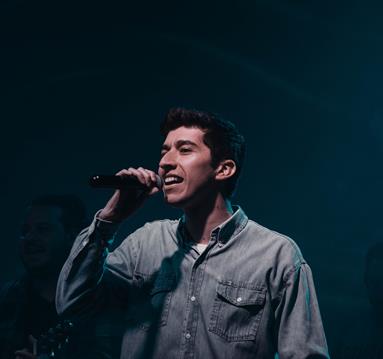 A Man Singing with a Microphone
