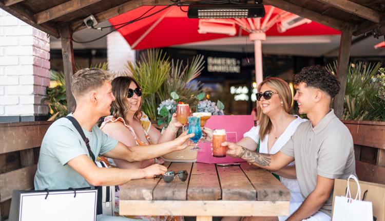 group of friends having a drink at the bar at Cheshire Oaks