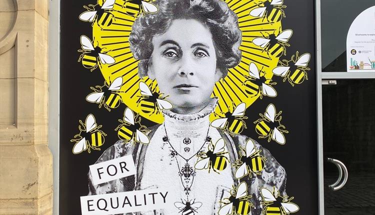 Photo of street artwork with the words 'Manchester Queen Bee for Equality'