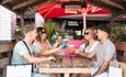 group of friends having a drink at the bar at Cheshire Oaks