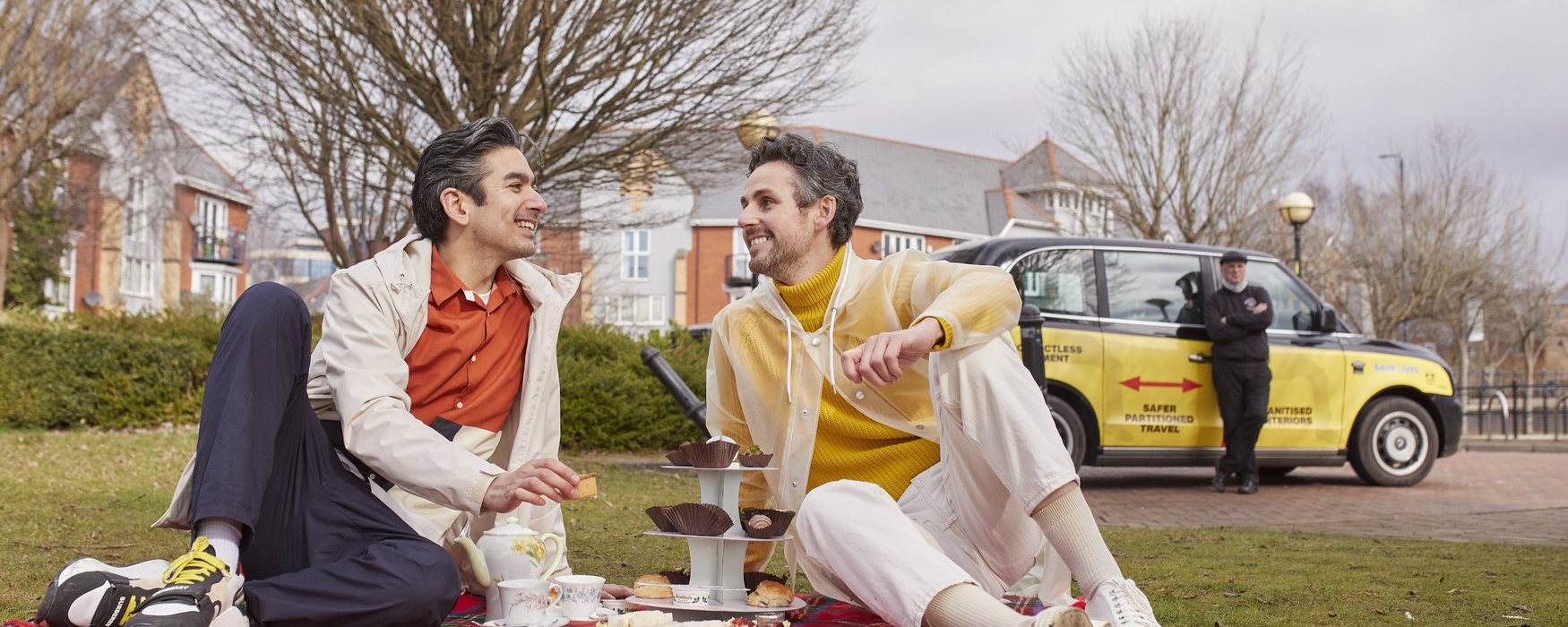 2 men enjoying afternoon tea outdoors in Manchester