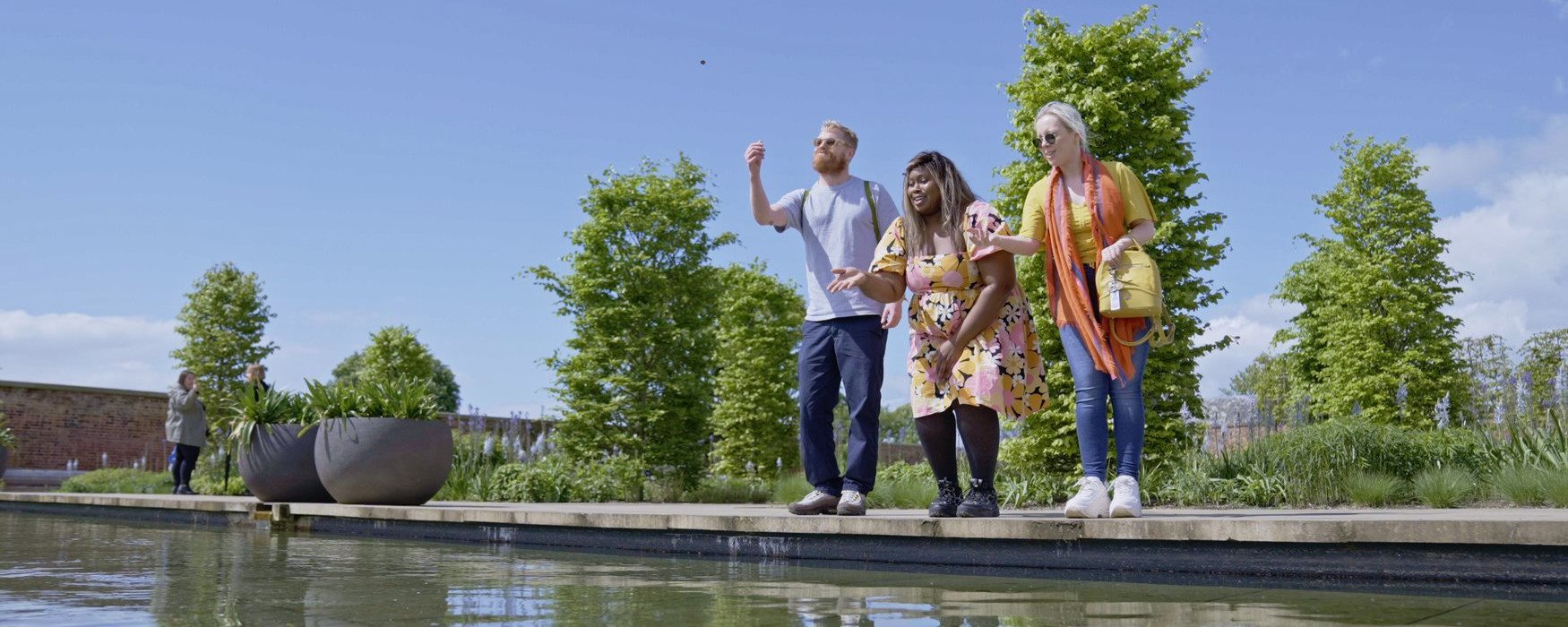 Group of people by a pond at RHS Bridgewater Gardens