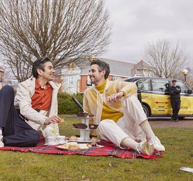 2 men with a picnic outdoors in Manchester