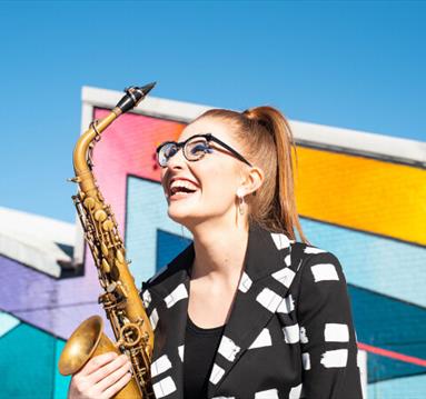 Jess Gillam with a Saxophone