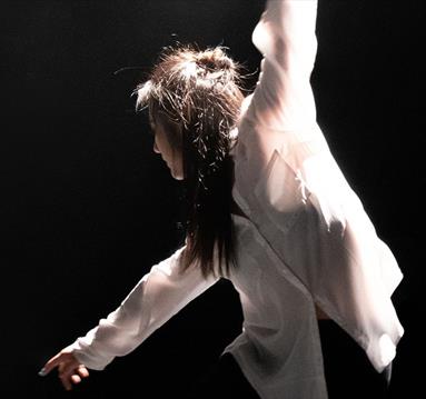 Person in casual wear dancing onstage