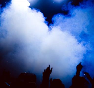 People with arms in the air in a club