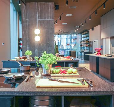 Kitchen area set up with knife, chopping board, and ingredients