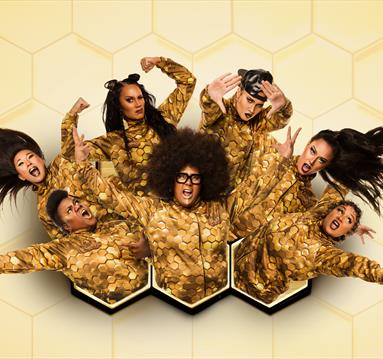 Hot Brown Honey cast in gold costumes