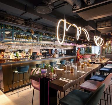 Bar and tables at Motley Manchester