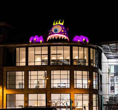 Inflatable halloween monster installed above Next, Manchester
