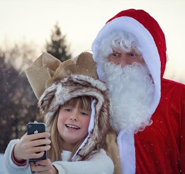 Father Christmas taking selfie with a girl
