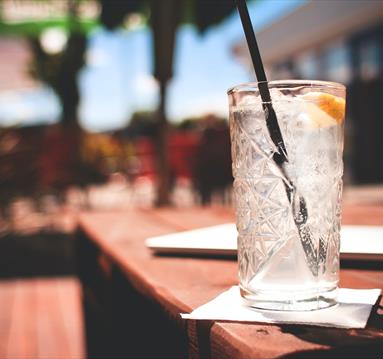 Gin glass on a table in the sun