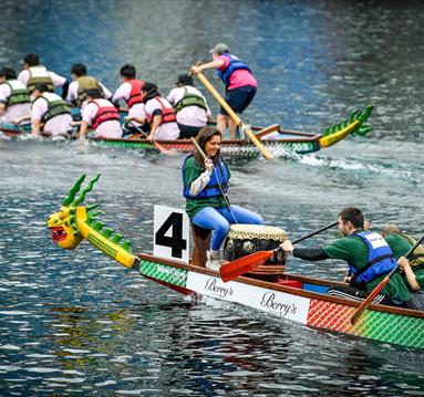 2 teams competing in a dragon boat race