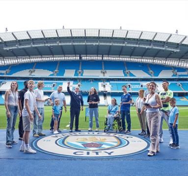 Group of fans inside the Etihad Stadium on a tour