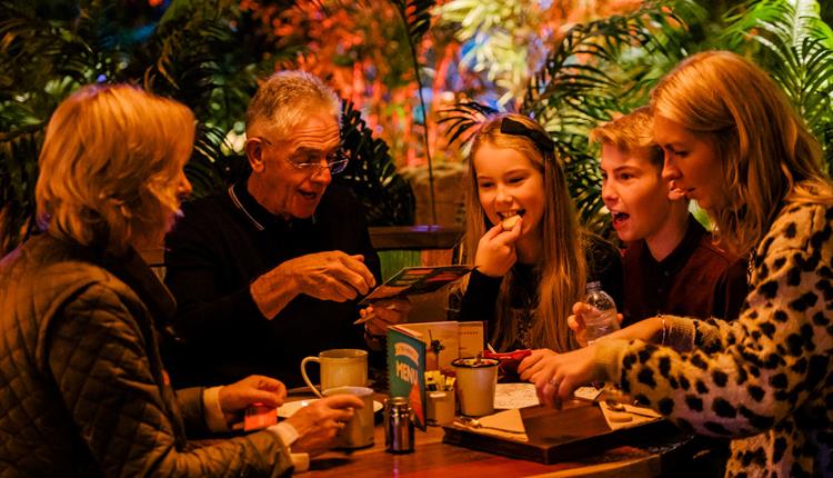 Family enjoying food at Treetop Adventure Golf