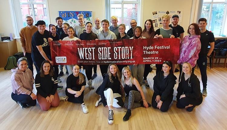Actors holding a poster; West Side Story