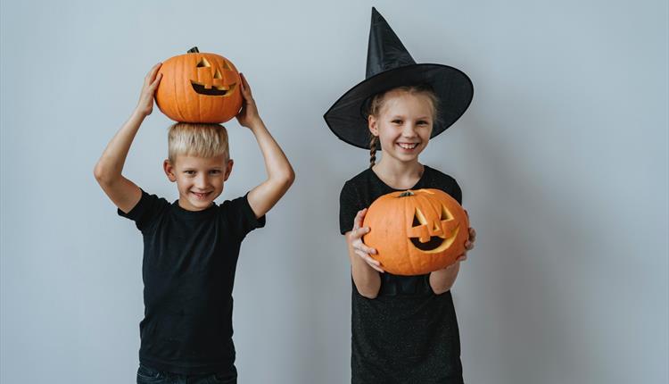 Boy and Girl Holding Jack O Lantern
