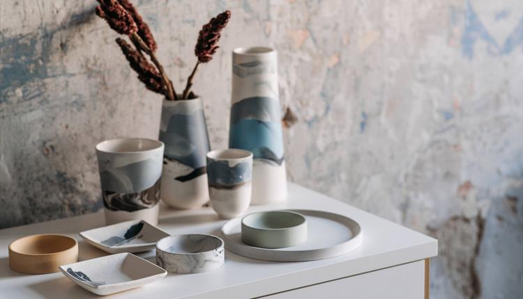 Earthenware Products on White Table
