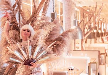 A person dressed in feather costume