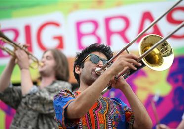 2 people playing brass instruments