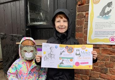 children holding a booklet