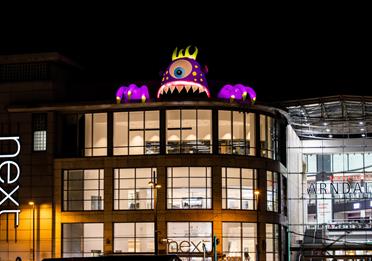 Inflatable halloween monster installed above Next, Manchester