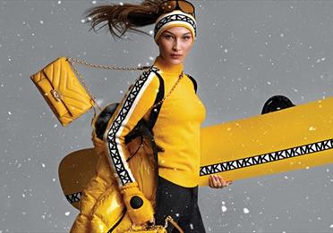 Model wearing Michael Kors ski wear and accessories.