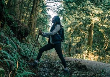 A Woman Hiking in a Forest