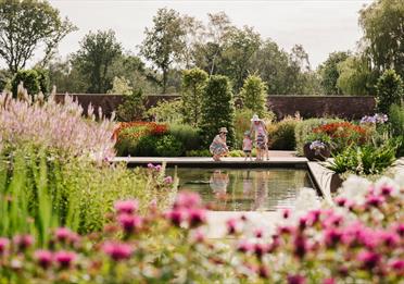 Family overlooking a small pond at RHHS Garden Bridgewater