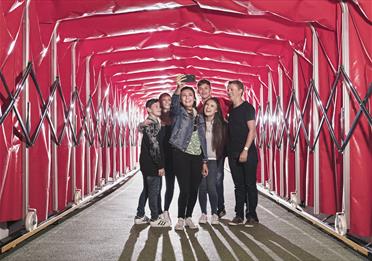 Family taking a selfie in the tunnel at the Manchester United Museum and Stadium Tour