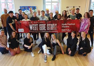 Actors holding a poster; West Side Story