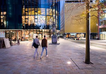 Two people walking in the evening, HOME in the background