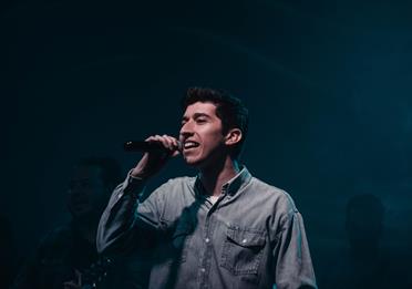 A Man Singing with a Microphone
