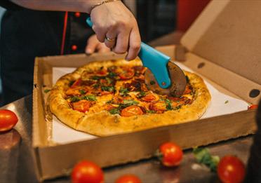 pizza being cut