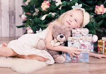 Girl Lying Beside Three Gift Boxes
