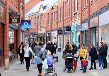 Shoppers walking along high street in Prince Bishop's Palace